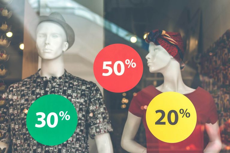 A store with Mannequins, displaying discounts of various percentages during sale.